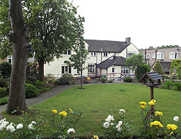 Photograph of exterior and gardens at Cairn Home