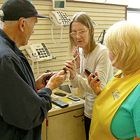 Photo of participants at Visual Impairment training session learning sighted guiding, with one participant wearing a blindfold