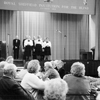 Black and white photograph of singers entertaining SRSB clients
