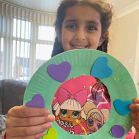 Photo of one of our younger clients with a craft activity from one of our packs