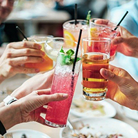 Photo of some peoples hands doing a cheers with glasses of drink