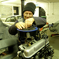 Photograph of John working on a car