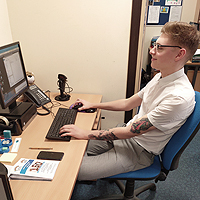 Photo of Taylor working at his computer