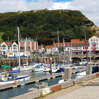 Photo of Scarborough harbour with boats and castle in background