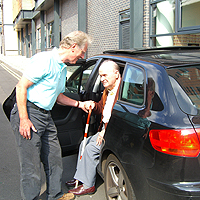 Photograph of volunteer driver helping SRSB client out of a car