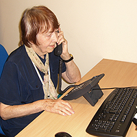 Photograph of one of SRSB's Tele-Friend volunteers on the phone
