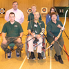 Photograph of clients in archery group holding bows and arrows
