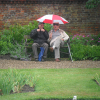 Photograph of two SRSB clients sat on a bench at Hodstock Gardens