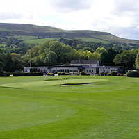 Photograph of Sickleholme golf course with clubhouse and hills in background