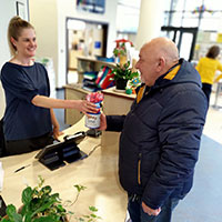 Photo of someone handing an elephant collection tin to someone else