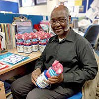 Photo of a volunteer organising collection tins