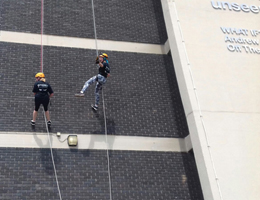Photo of some people abseiling down the Owen Building in Sheffield