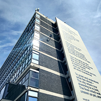 Photo of someone abseiling down the Owen Building