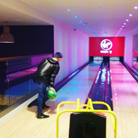 Photograph of someone doing ten pin bowling