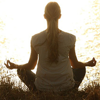 Photo of someone sitting cross legged meditating