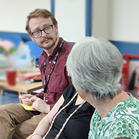 Photo of Jackchatting to some clients at a Coffee Morning