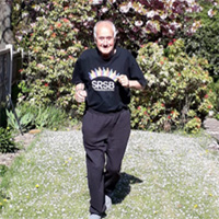 Photo of Graham running in his garden