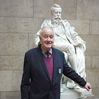 Photo of Graham at Sheffield Town Hall standing next to a statue
