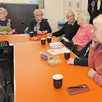 Photo of some members of the group chatting in a previous meeting