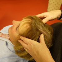 Photograph of someone massaging somones scalp