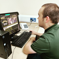 Photo of Jake sitting in front of a computer