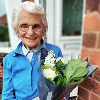 Photo of Margaret holding some flowers
