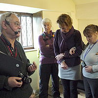 Photograph of people listening to audio descriotion at Bishops House