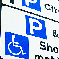 Photograph of a road sign with parking information