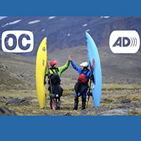 Image of two people high 5ing holding canoes with open cation symbol and audio description symbol