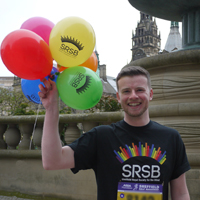 Photograph of Tom with balloons before the race