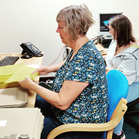 Photo of two people working on a mailshot