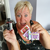 Photo of Tina holding some of the goodies from her wellbeing pack