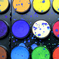 Photo of some different coloured paints on pots