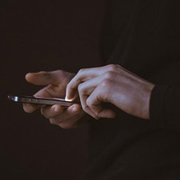 Close up of someones hands using a phone