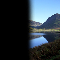 Photo of a lake and scenery with half of the image darkened