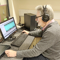 Photo of technician sat at a computer