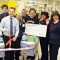 Photograph of Tesco staff presenting a cheque to SRSB
