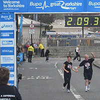 Photograph of SRSB runner crossing finish line in 2012