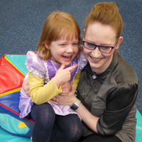 Photograph of one of our young clients with her mum