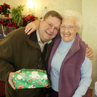 Photograph of client receiving a Christmas gift from SRSB staff member
