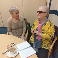 Photo of two people chatting in a support group