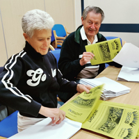 Photo of Julie and Dennis at SRSB working on the client newsletter mailout